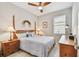 Bedroom features neutral walls, wood furniture, and natural light from the window at 2766 Purple Meadow Ct, Minneola, FL 34715