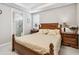 Comfortable bedroom featuring a tray ceiling, and view to a ensuite bathroom at 2766 Purple Meadow Ct, Minneola, FL 34715