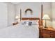 Inviting bedroom with wooden furniture, a comfortable bed, and warm, inviting lighting at 2766 Purple Meadow Ct, Minneola, FL 34715