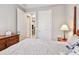 This bedroom features an open doorway with matching doors and a wooden nightstand at 2766 Purple Meadow Ct, Minneola, FL 34715