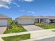 The property features a well-manicured lawn, a paver driveway, and a two-car garage, all adding to its curb appeal at 2766 Purple Meadow Ct, Minneola, FL 34715