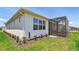 Exterior view of home with screen patio, well-maintained lawn and garden at 2766 Purple Meadow Ct, Minneola, FL 34715