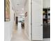 Hallway with tile flooring that provides a glimpse into the open floor plan and kitchen area at 2766 Purple Meadow Ct, Minneola, FL 34715