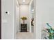 Inviting hallway featuring neutral walls, decorative table, and tile flooring at 2766 Purple Meadow Ct, Minneola, FL 34715