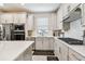 Modern kitchen with stainless steel appliances, sleek countertops, and ample cabinet space at 2766 Purple Meadow Ct, Minneola, FL 34715