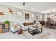 Inviting living area featuring comfortable seating, stylish decor, and a view of the kitchen at 2766 Purple Meadow Ct, Minneola, FL 34715
