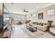 Spacious living room with neutral tones, large windows, and a cozy seating area at 2766 Purple Meadow Ct, Minneola, FL 34715