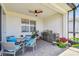 Covered outdoor patio featuring brick flooring, a ceiling fan, and a stainless-steel gas grill at 2766 Purple Meadow Ct, Minneola, FL 34715