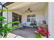 Covered patio includes brick flooring, ceiling fan, and a stainless-steel gas grill for outdoor entertaining at 2766 Purple Meadow Ct, Minneola, FL 34715