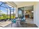 Screened patio featuring brick flooring, a seating area and sliding glass doors to the home's interior at 2766 Purple Meadow Ct, Minneola, FL 34715