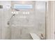 Modern walk-in shower with luxurious tile, shower head, and seamless glass enclosure at 2766 Purple Meadow Ct, Minneola, FL 34715