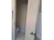 Bathroom showing the white toilet and tile flooring, view through an open door at 2863 Middleton Cir, Kissimmee, FL 34743