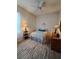 A bright bedroom featuring a ceiling fan, lamps, and a decorative rug at 2863 Middleton Cir, Kissimmee, FL 34743