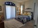 Bright bedroom with a large window, neutral walls, and a comfortable bed with decorative pillows at 2863 Middleton Cir, Kissimmee, FL 34743