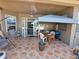 Enjoy this large covered patio, complete with a ceiling fan, seating, and dining area at 2863 Middleton Cir, Kissimmee, FL 34743