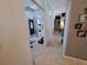 Hallway with tile flooring and framed décor leading to the front door at 2863 Middleton Cir, Kissimmee, FL 34743