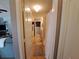 Hallway with views of the bathroom and living area, tiled floor and neutral walls at 2863 Middleton Cir, Kissimmee, FL 34743