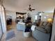 Open-concept living room featuring tile flooring, comfortable seating, and a ceiling fan at 2863 Middleton Cir, Kissimmee, FL 34743