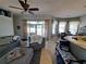 Cozy living room with ample seating, ceiling fan, and natural light from adjacent dining area at 2863 Middleton Cir, Kissimmee, FL 34743