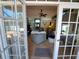 Open living room view through french doors, showcasing comfortable seating and neutral decor at 2863 Middleton Cir, Kissimmee, FL 34743