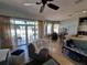 Relaxing living area with neutral colors, tile floor, ceiling fan, and outside access at 2863 Middleton Cir, Kissimmee, FL 34743