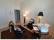 Cozy office area with dark-toned carpeting, a desk, a lamp, and a printer at 2863 Middleton Cir, Kissimmee, FL 34743