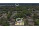 Aerial view of a house surrounded by lush trees, with lakes in the distance at 2918 Croton Rd, Apopka, FL 32703