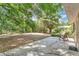 Large backyard with a concrete patio, mature trees, and lush greenery at 2918 Croton Rd, Apopka, FL 32703