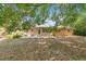 A spacious backyard, showcasing a cozy patio area and mature shade trees at 2918 Croton Rd, Apopka, FL 32703