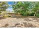 Expansive backyard featuring lush greenery, mature trees, and a fire pit at 2918 Croton Rd, Apopka, FL 32703