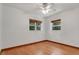 Bright bedroom with light hardwood floors and two windows with tree views at 2918 Croton Rd, Apopka, FL 32703