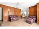 Spacious living room featuring wood paneling, and stylish hardwood floors at 2918 Croton Rd, Apopka, FL 32703
