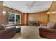 Cozy living room featuring wood paneling, hardwood floors, and comfortable seating at 2918 Croton Rd, Apopka, FL 32703