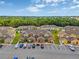 Aerial view showcasing the community with well-maintained townhomes, parking, and green spaces at 318 Australian Way, Davenport, FL 33897