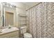 Bathroom featuring a toilet, shelving and a tiled shower curtain. Provides a functional space at 318 Australian Way, Davenport, FL 33897