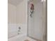 Modern bathroom showcasing a sleek glass shower, tiled walls, and a built-in bathtub at 318 Australian Way, Davenport, FL 33897