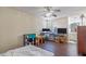 Comfortable bedroom featuring wood flooring, natural light, and a view into the ensuite bathroom at 318 Australian Way, Davenport, FL 33897
