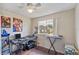 Bedroom with a ceiling fan, natural light, and wood flooring. Perfect for a studio or office at 318 Australian Way, Davenport, FL 33897