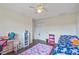 Charming bedroom featuring a ceiling fan and a cozy atmosphere with play area at 318 Australian Way, Davenport, FL 33897
