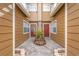 Townhome courtyard featuring matching red doors and a neatly maintained landscape at 318 Australian Way, Davenport, FL 33897