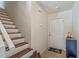 Entryway featuring tiled floor, stairs with wood trim, and ample lighting, welcoming you home at 318 Australian Way, Davenport, FL 33897