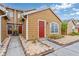 Charming townhome featuring a red door, landscaped yard, and quaint architectural details at 318 Australian Way, Davenport, FL 33897