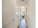 Hallway features wood flooring and leads to rooms with natural light, enhancing the home's inviting ambiance at 318 Australian Way, Davenport, FL 33897