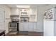 Functional kitchen with white cabinets, appliances, and laminate flooring at 318 Australian Way, Davenport, FL 33897