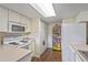 Bright kitchen with white appliances, laminate flooring, and practical storage solutions at 318 Australian Way, Davenport, FL 33897