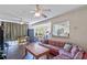 Inviting living room featuring hardwood floors, ceiling fans, and seamless access to the kitchen at 318 Australian Way, Davenport, FL 33897