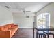 The bright living room features a vaulted ceiling, fan, and a large arched window at 318 Australian Way, Davenport, FL 33897