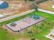 Overhead view of a community playground with slides, swings, benches, and palm trees at 318 Australian Way, Davenport, FL 33897