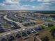 A scenic aerial captures a modern community with meticulously planned streets, manicured lawns, and a variety of home styles at 3341 Lounging Wren Ln, Bartow, FL 33830