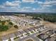 An aerial view shows a well-planned community layout with modern homes, solar panel installations, and landscaped streets at 3341 Lounging Wren Ln, Bartow, FL 33830
